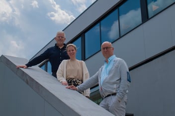 AXI Group CEO Ron van den Broeck and Contractify co-founders Herlinde De Buck and Steven Debrouwere at the AXI Group offices in Ghent, Belgium